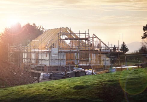 home being built of beautiful green pastures