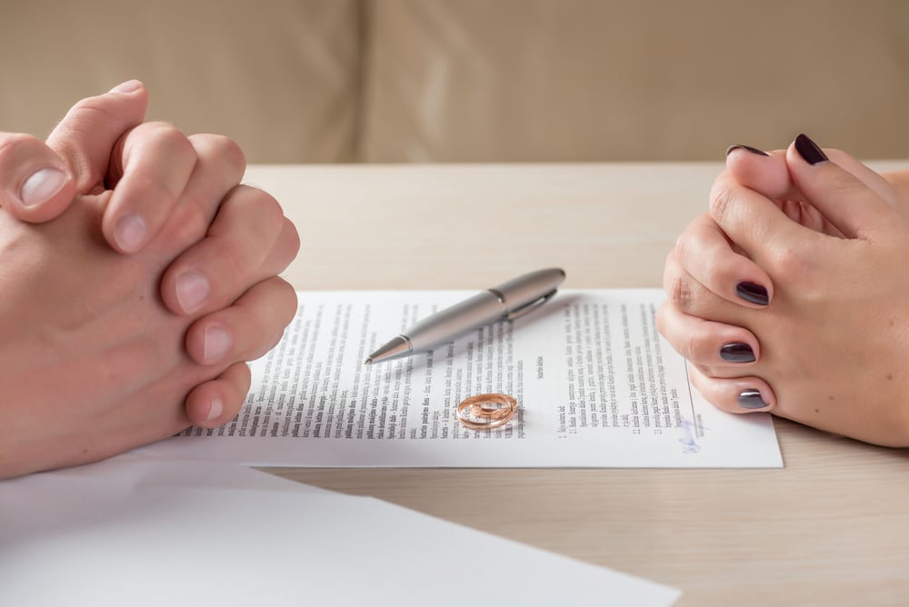 Wife And Husband Signing A Divorce Documents