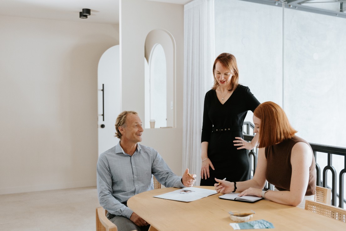Three lawyers chatting in bright room