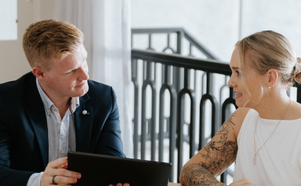 Screenshot 2025-10-29 120405 Young male accountant showing female graph on tablet