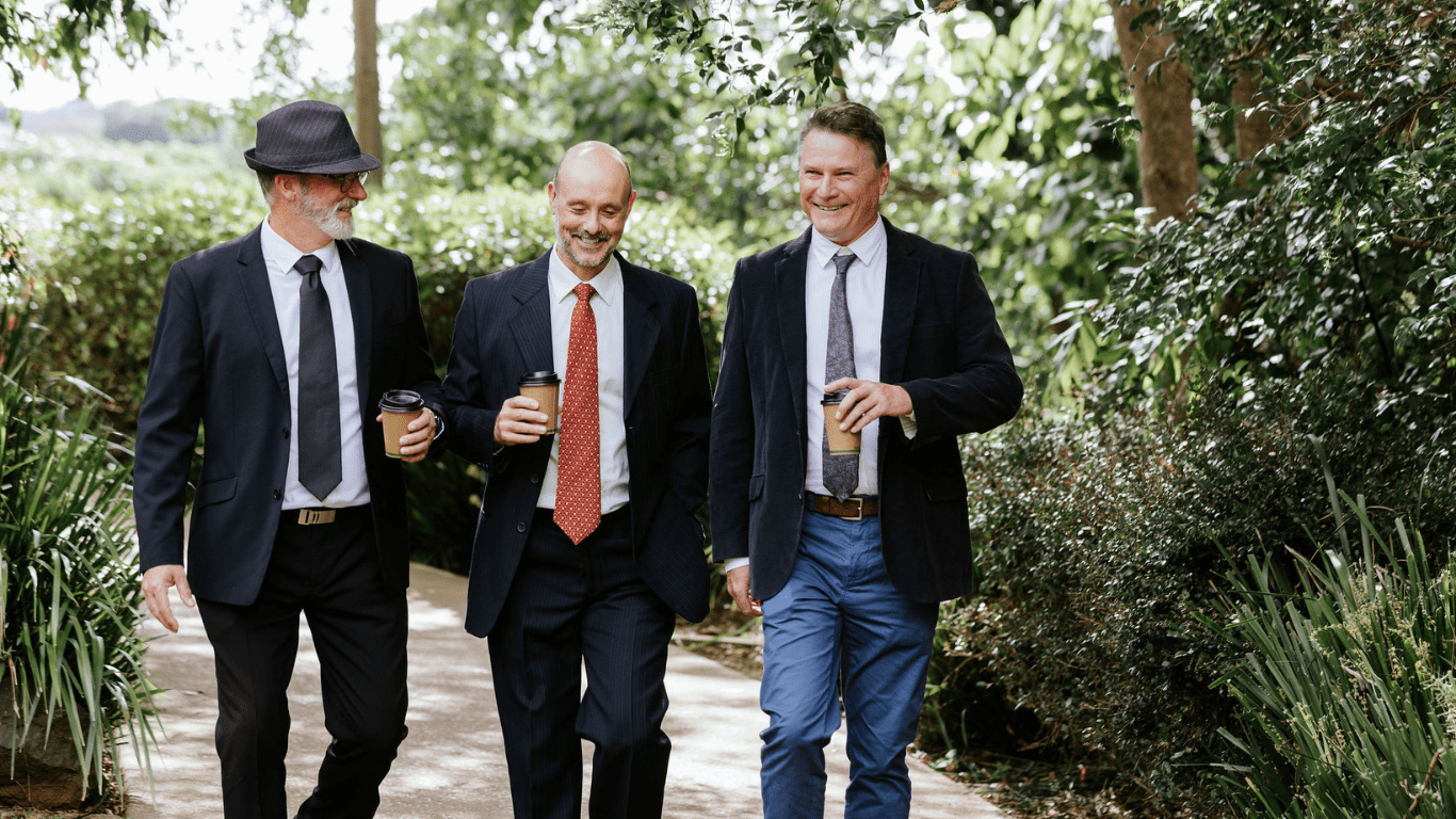 Four solicitors standing in a stone coloured room
