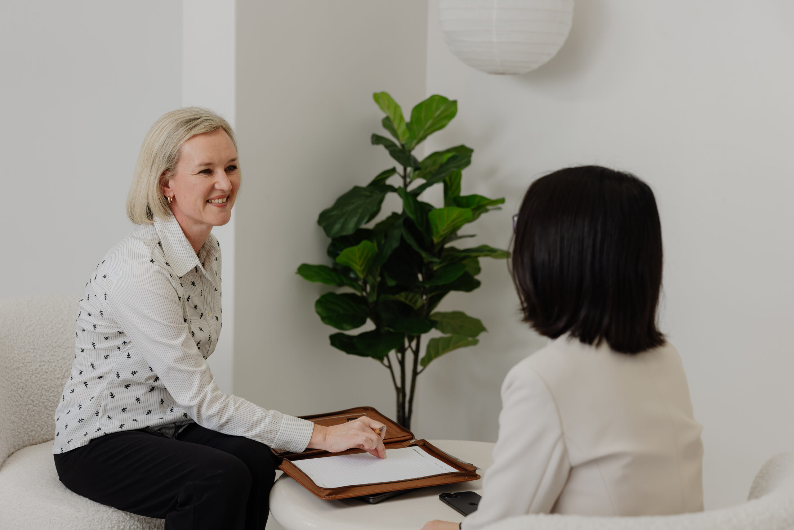 Lawyer discussing case details with a client on an iPad